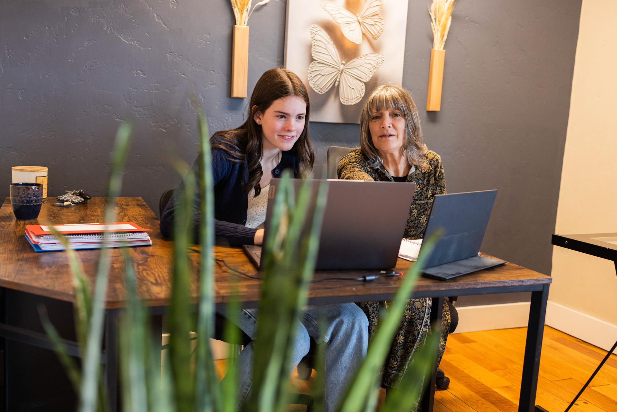 Image of Lee Ann Reeves, owner and founder of Bookkeeping by Design, working together with an employee on bookkeeping services for small businesses.